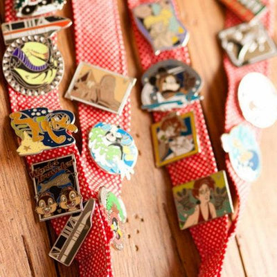 Lanyards with assorted pins on them.